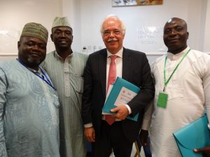 Amb Bert Ronhaar of the Nertherland in Suit flanked by participants at the Responsibilit to Report Seminar in Abuja