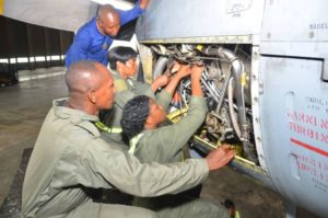 NAF Women of War and Engineers fixing a fighter jet